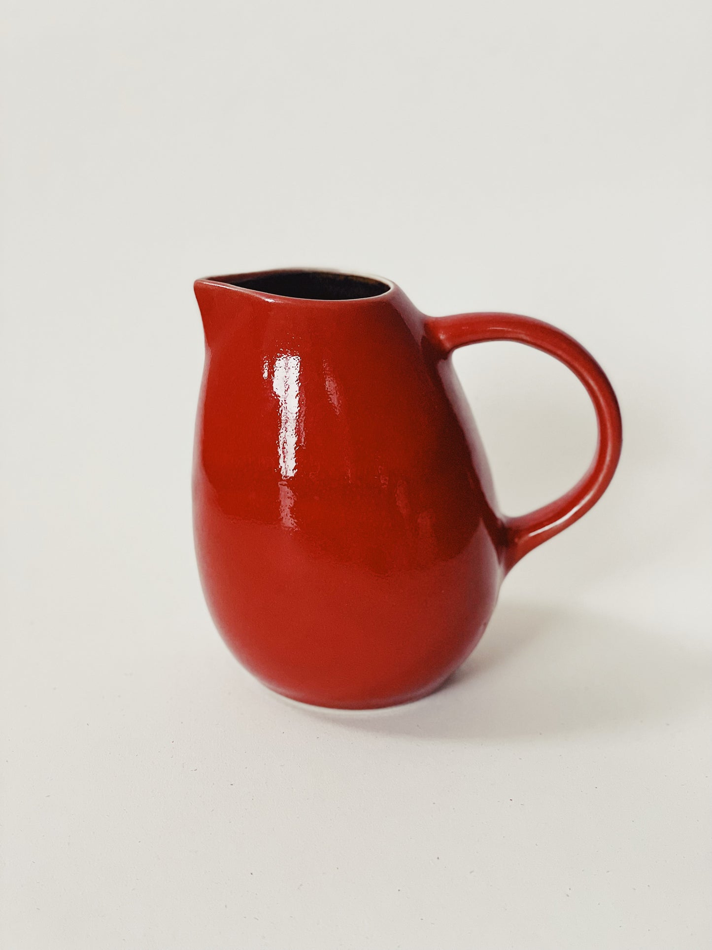 red creamer jug